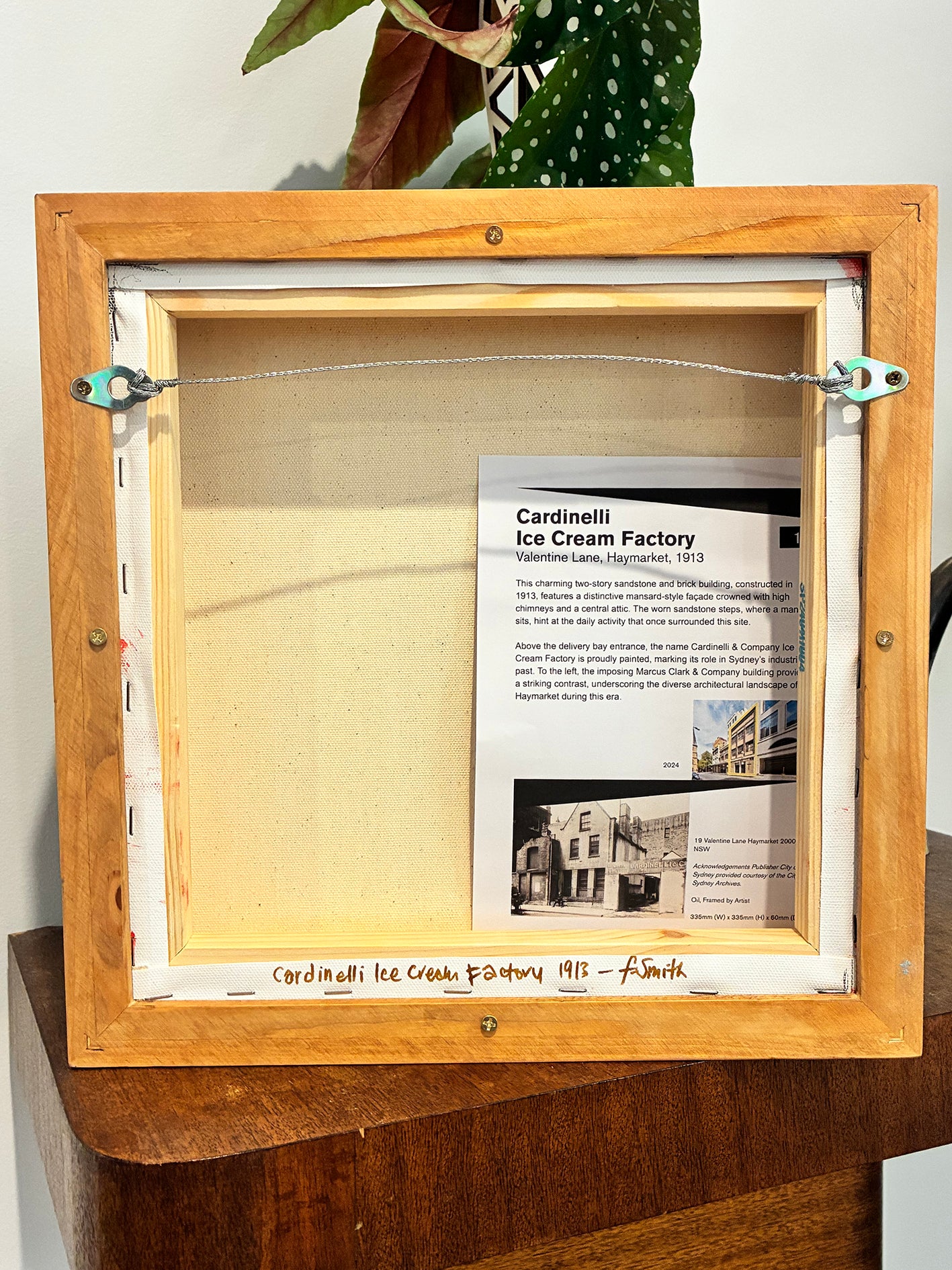 Wooden frame with a piece of paper inside, possibly an advertisement or informational text.