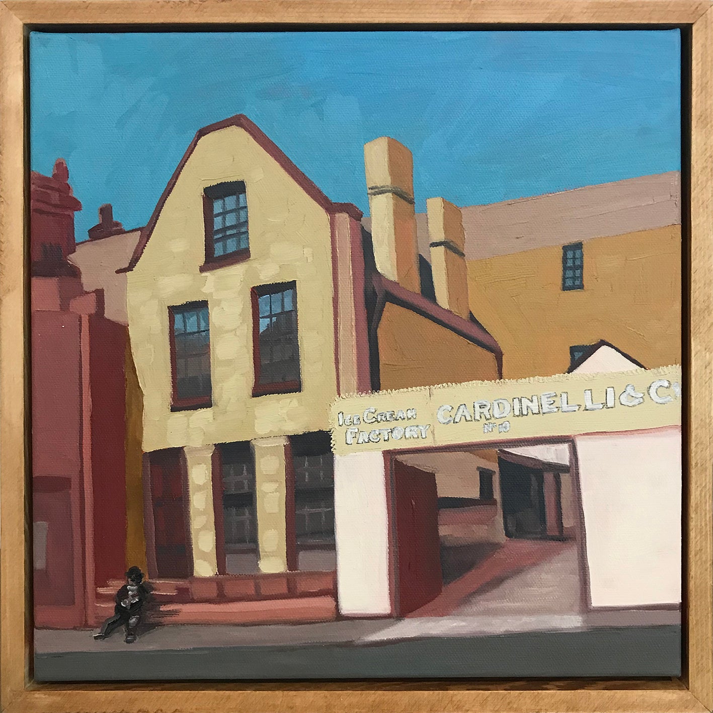 Painting of a street scene with buildings and a sign, framed in wood.