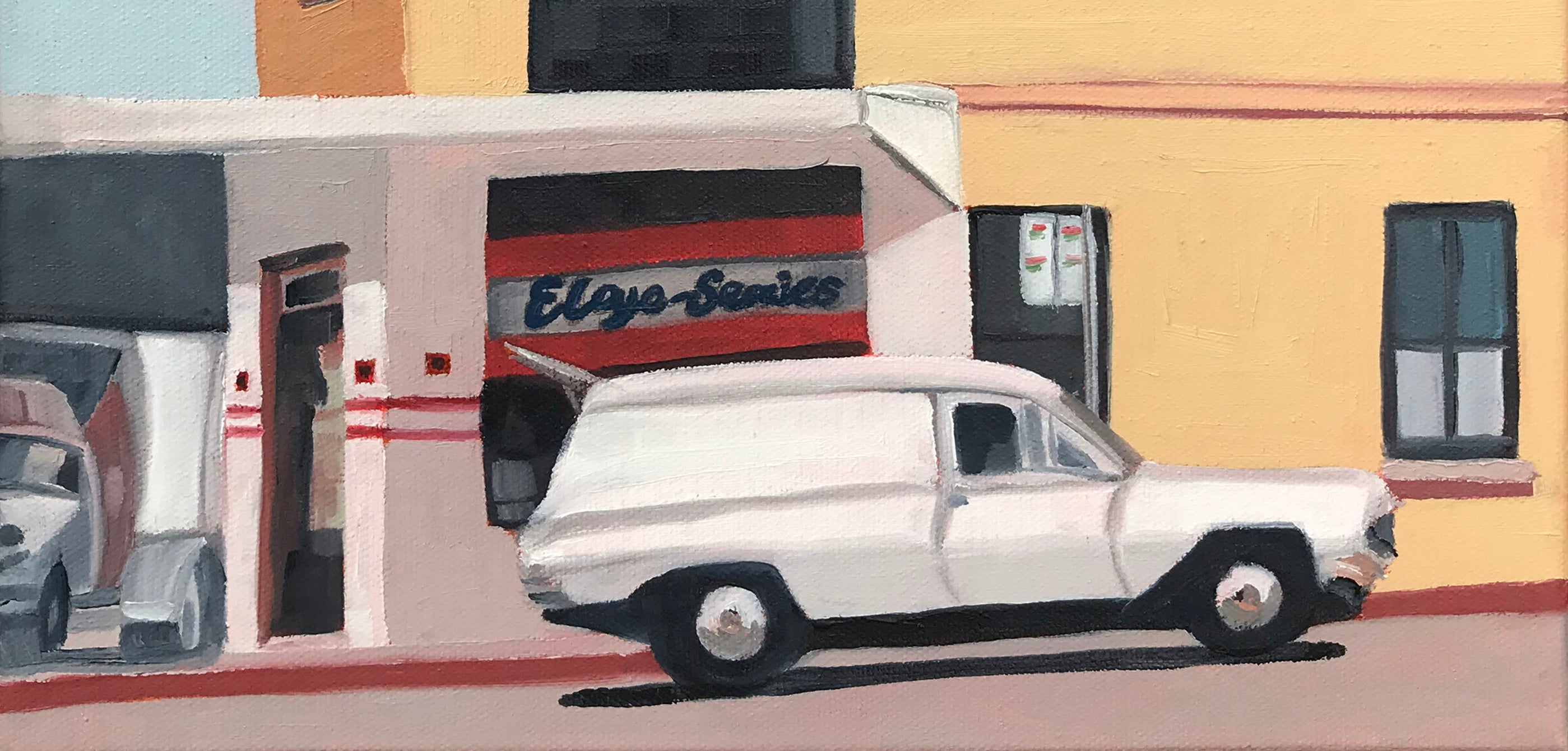 Vintage car parked in front of a building with 'El Paso Series' sign.