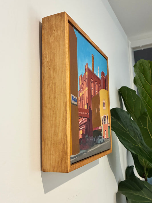 Wooden-framed television mounted on a wall with a colorful display.