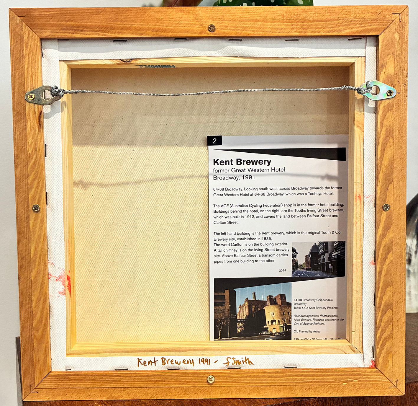 Wooden frame with a sign about Kent Brewery on a white wall