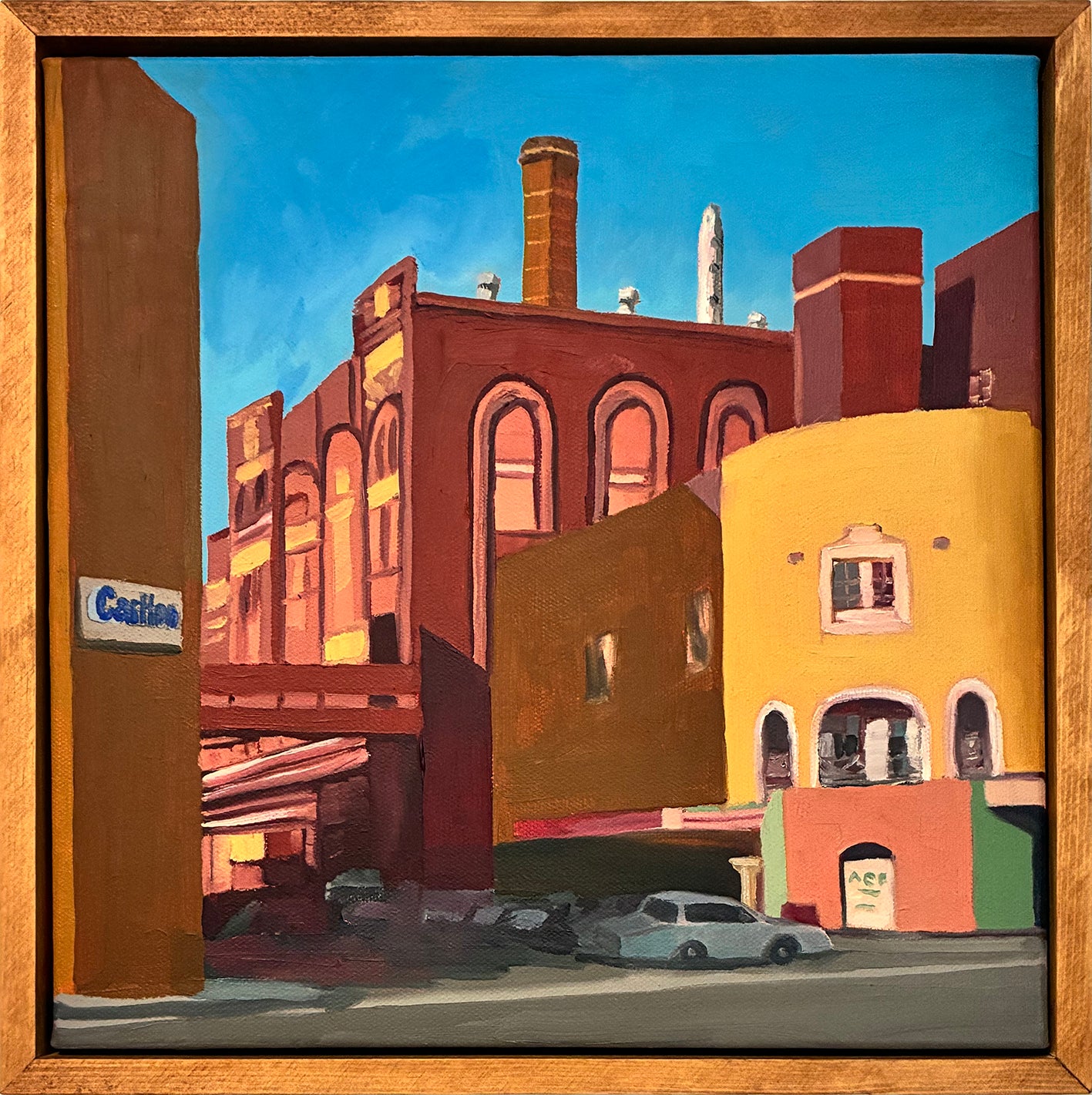 Painting of urban street scene with buildings and cars, framed in wood.