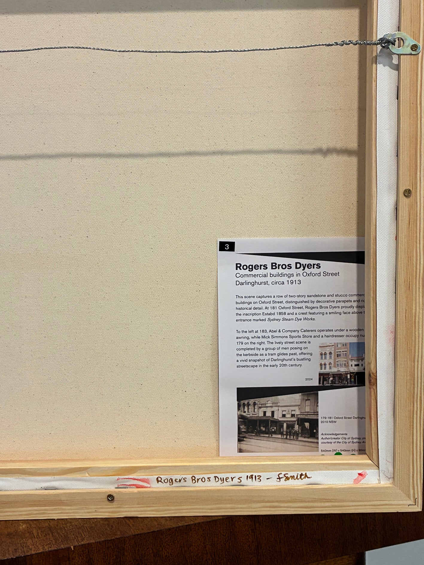 Framed document with text and a small image on a beige background
