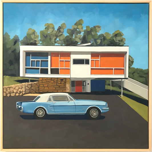 Modern house with colorful facade and a blue car in front