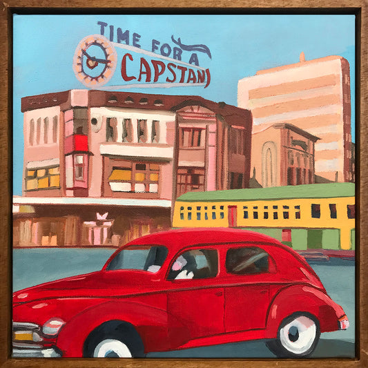 Vintage red car in front of a cityscape with 'Time for a Capstan' sign.
