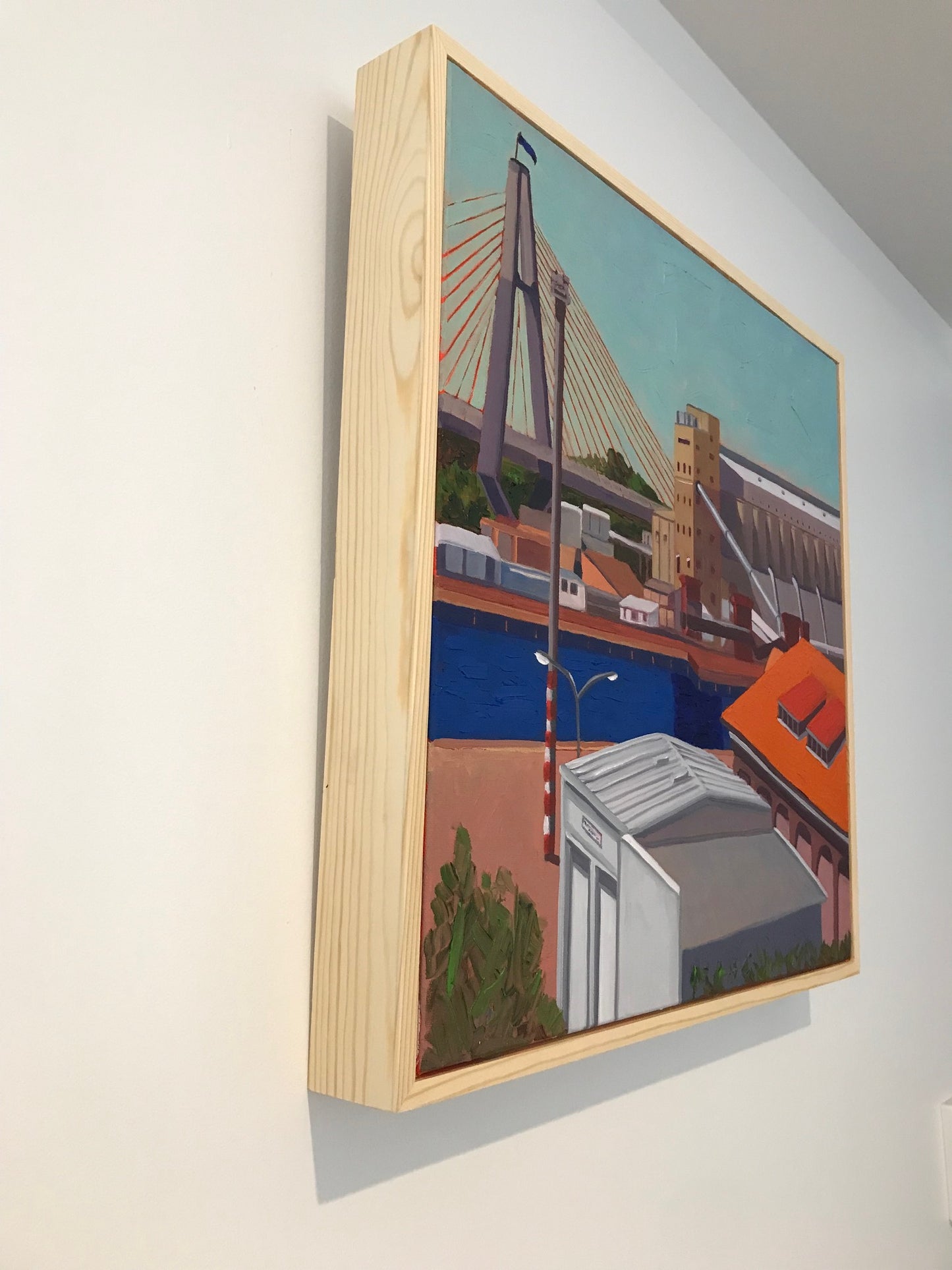 Wooden box with a colorful painting of a cityscape on top